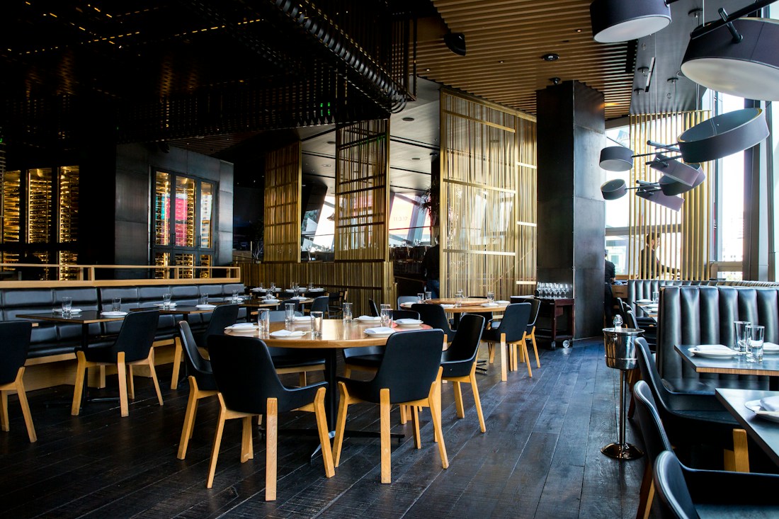 A thoughtfully designed restaurant dining room with warm golden details